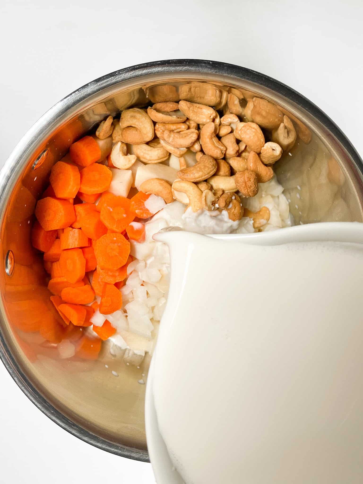 Cheese sauce ingredients in a stainless steel pot.