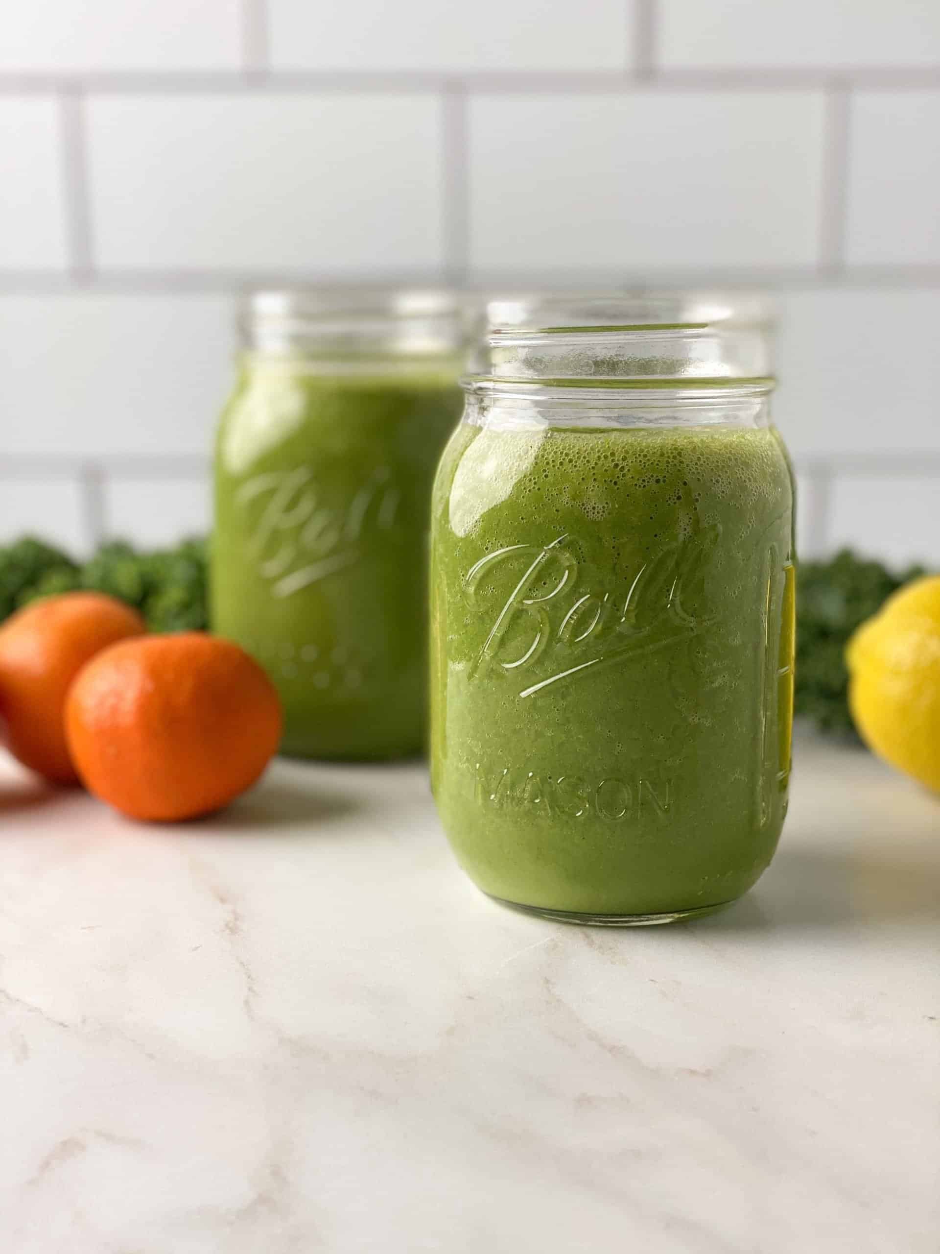 Two mason jars filled with green juice.