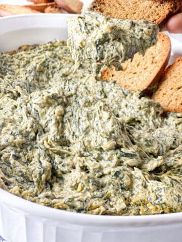 Whole wheat bread dipped in the dairy-free spinach artichoke dip.