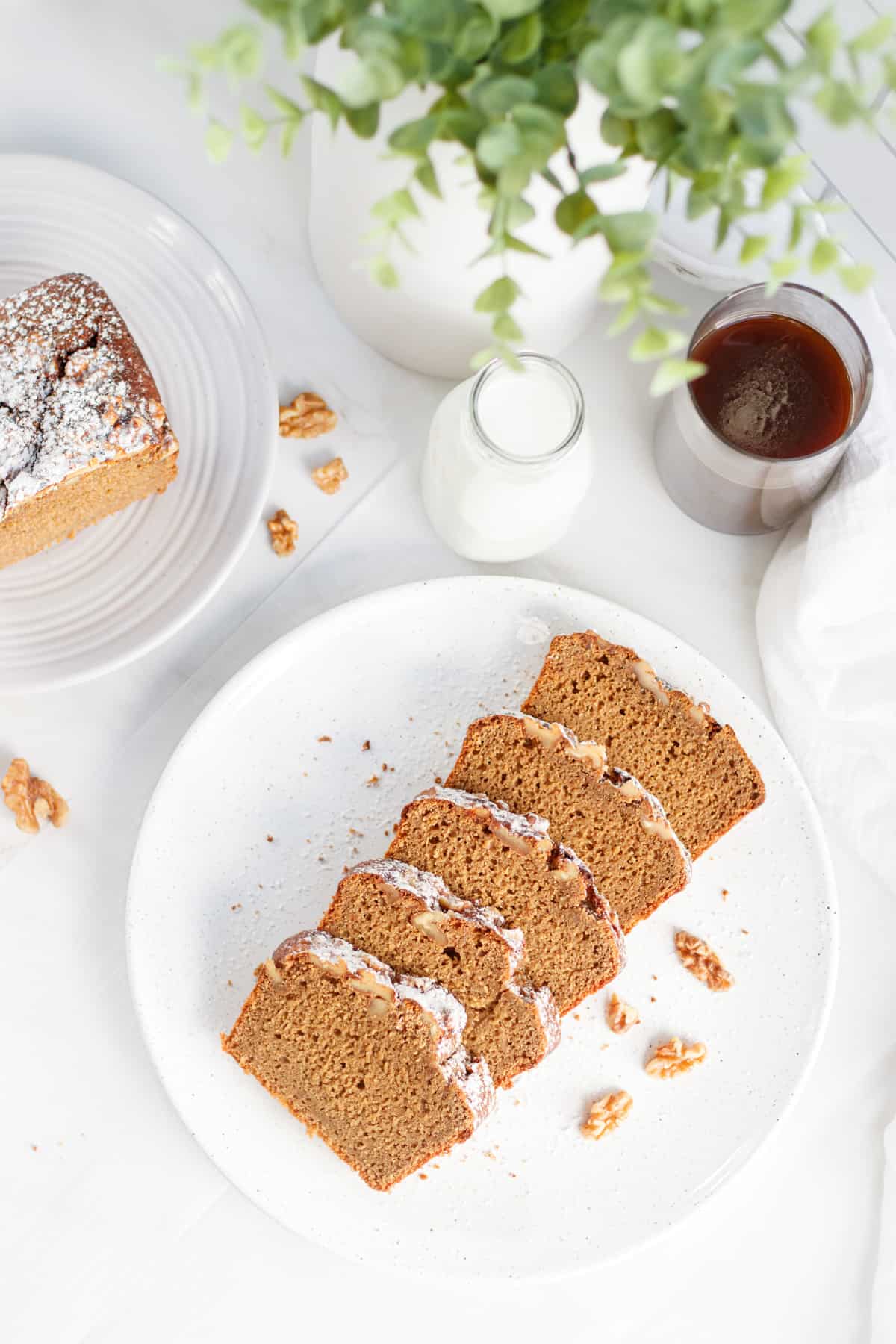 Sliced coffee and walnut loaf on a white plate.