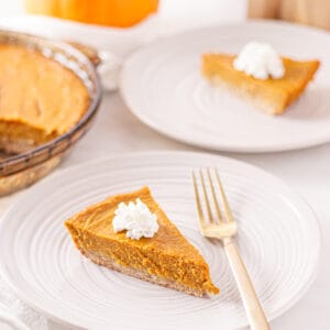 Pumpkin pie slice with dairy-free whipped cream.