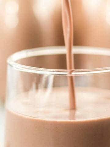 Vegan chocolate milk poured into a glass.