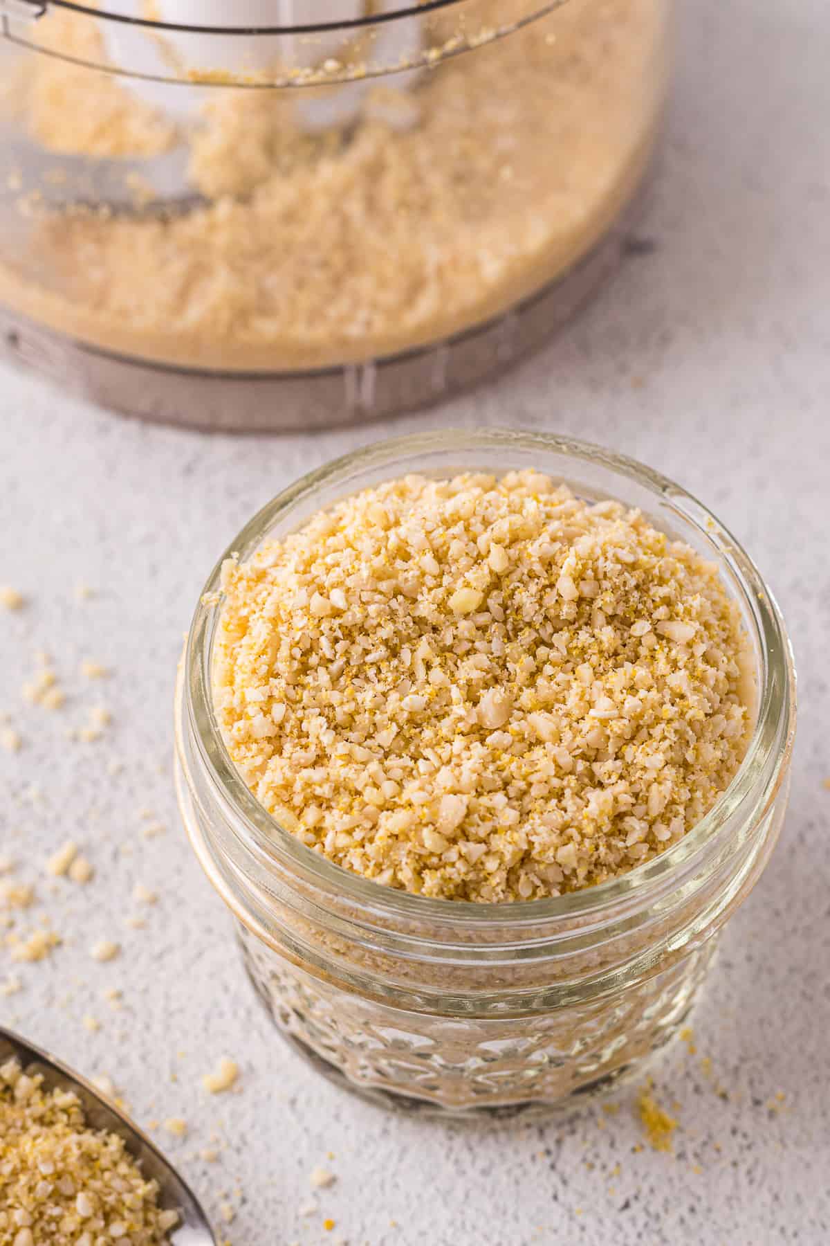 Dairy-free parmesan cheese in a glass jar.