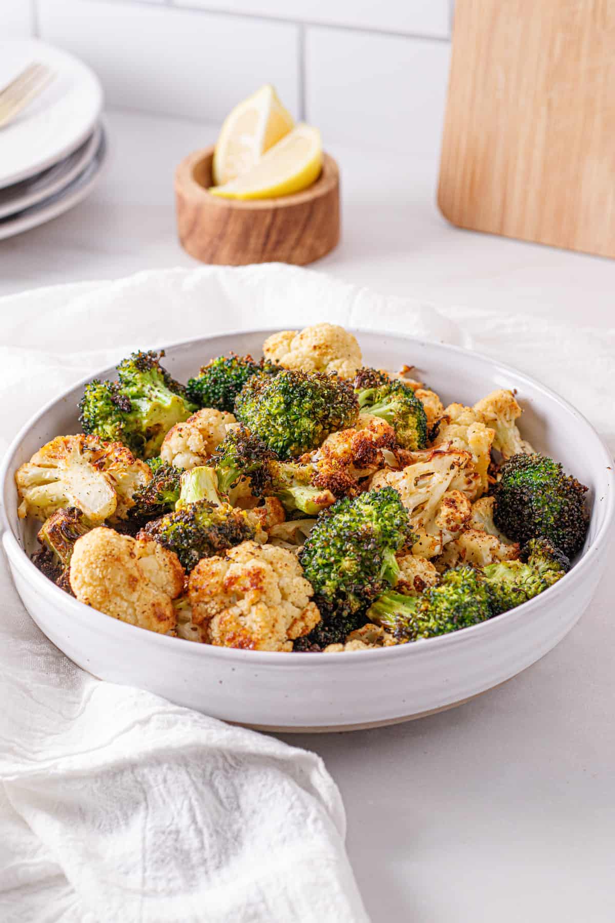 Air fryer broccoli and cauliflower in a white bowl.