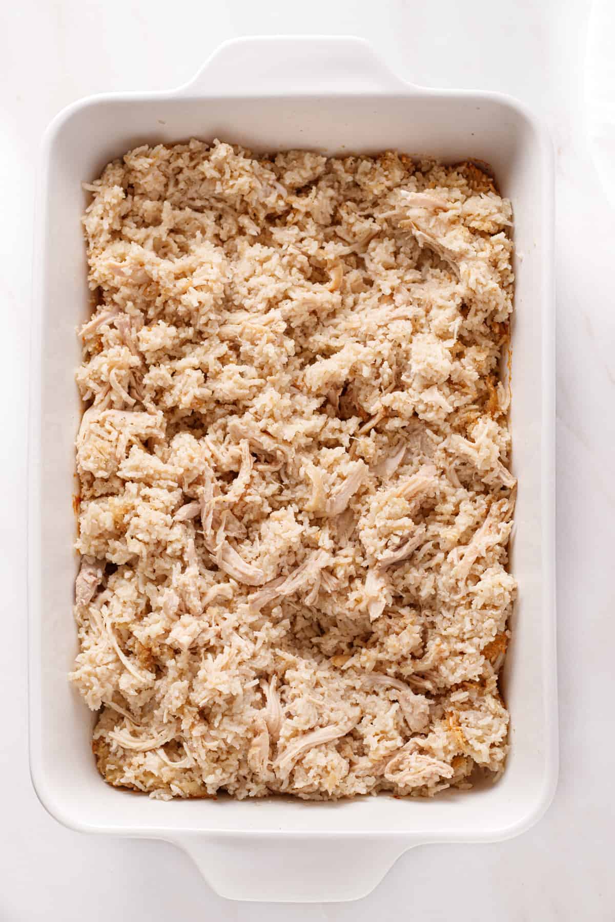 Cooked dairy-free chicken and rice casserole shredded and mixed up.