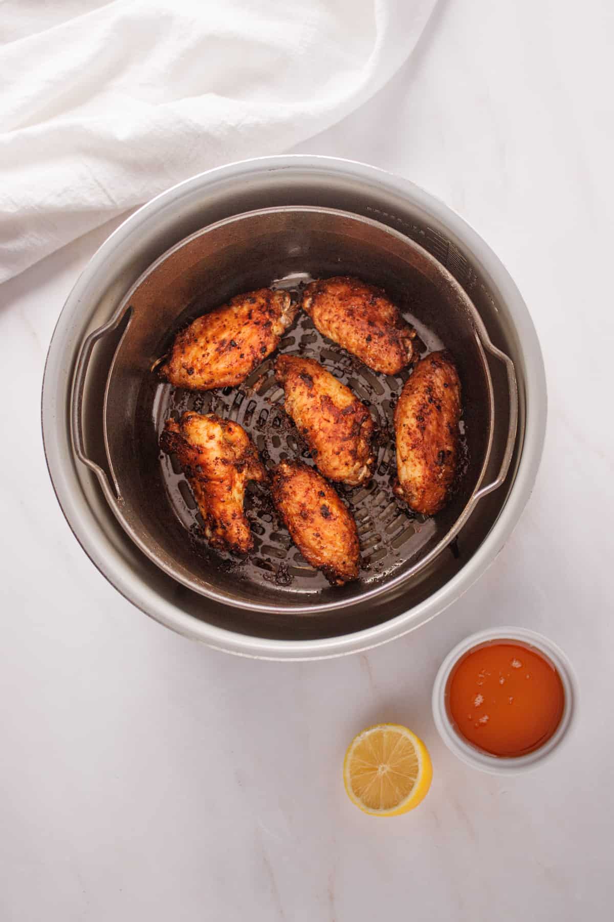 Cooked chicken wing pieces in the air fryer.