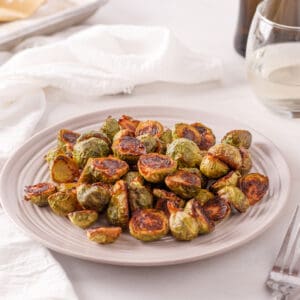 Marinated brussel sprouts on a white plate.