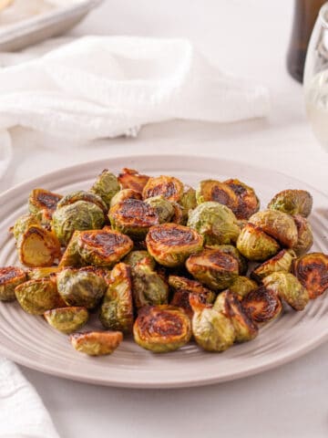 Marinated brussel sprouts on a white plate.