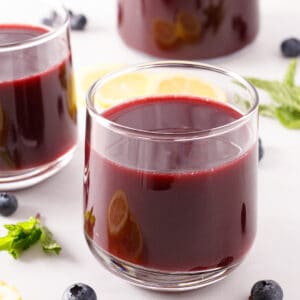 Blueberry juice in a glass cup.