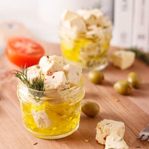 Vegan feta in small jars with olive oil.
