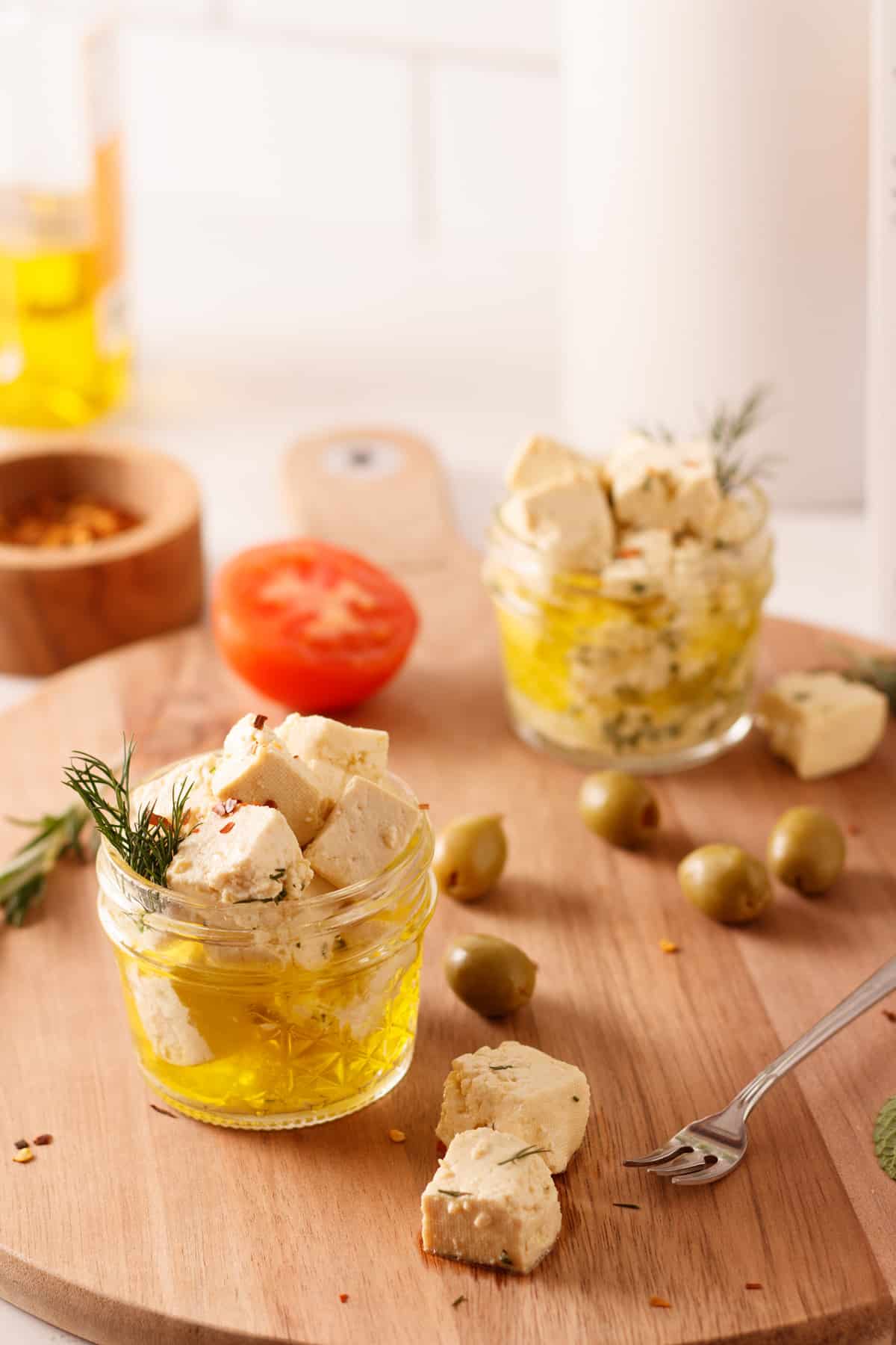 Vegan feta in small jars with olive oil.