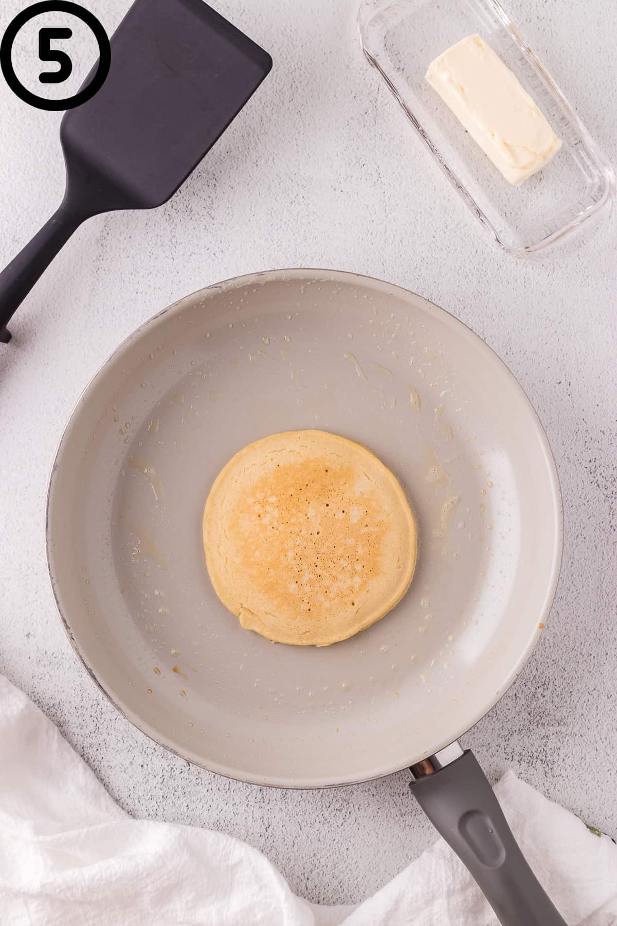 Oat milk pancake that has been flipped.