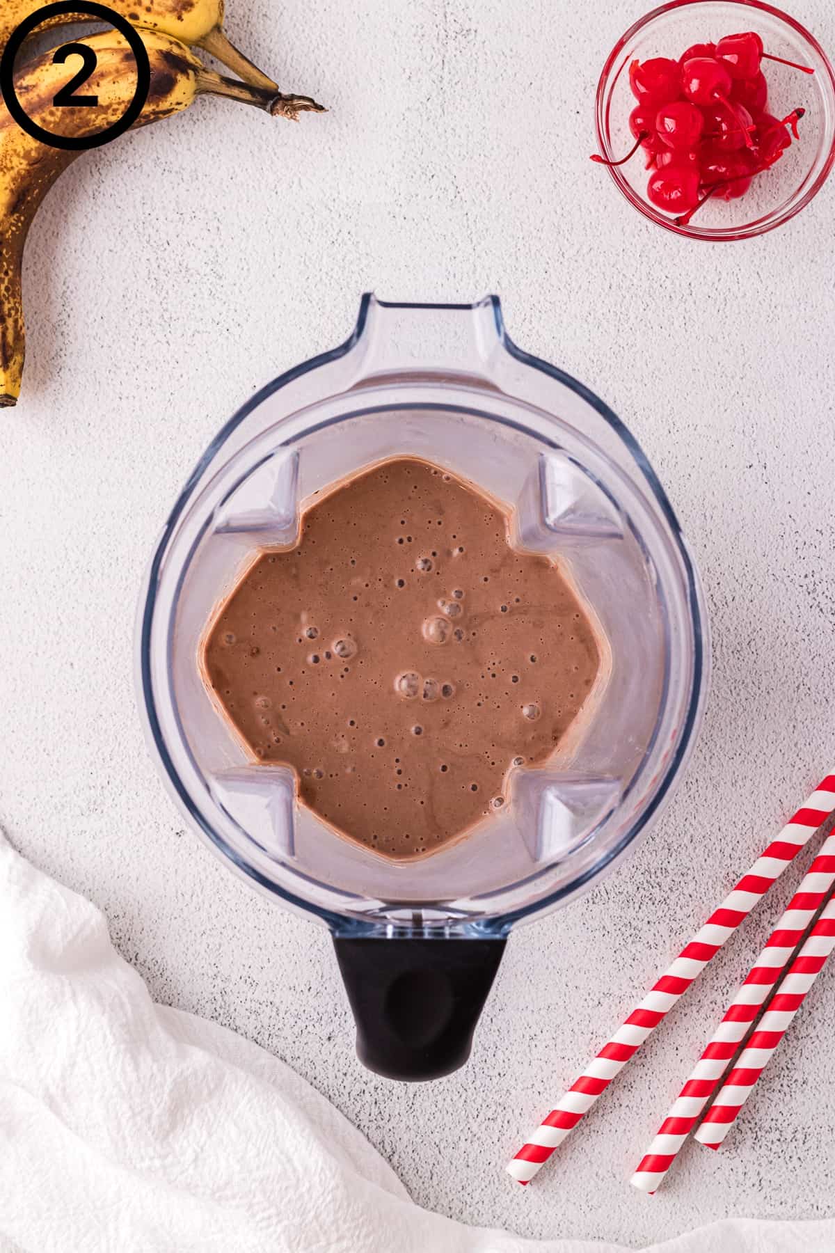 Chocolate banana milkshake in a blender.