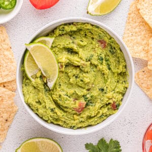 Guacamole without onions in a white bowl.