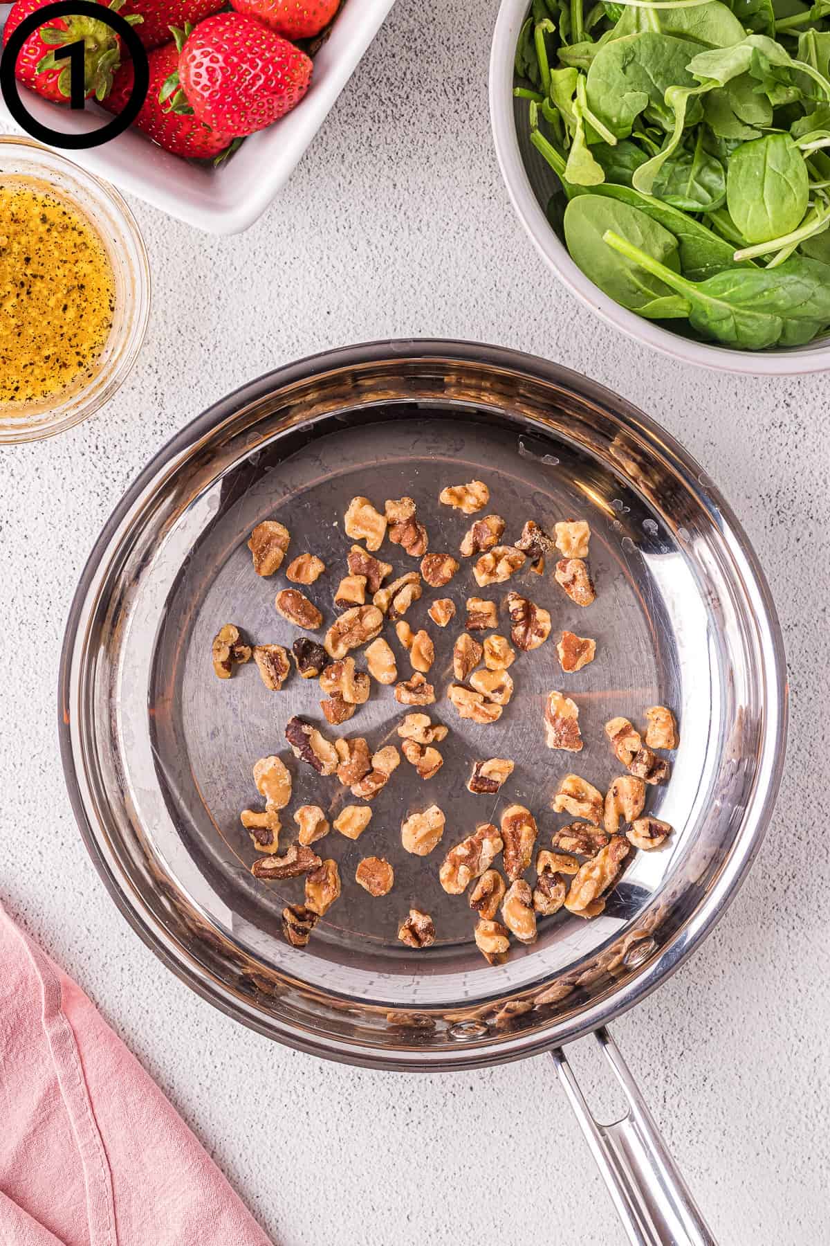 Toasted walnuts in a pan.