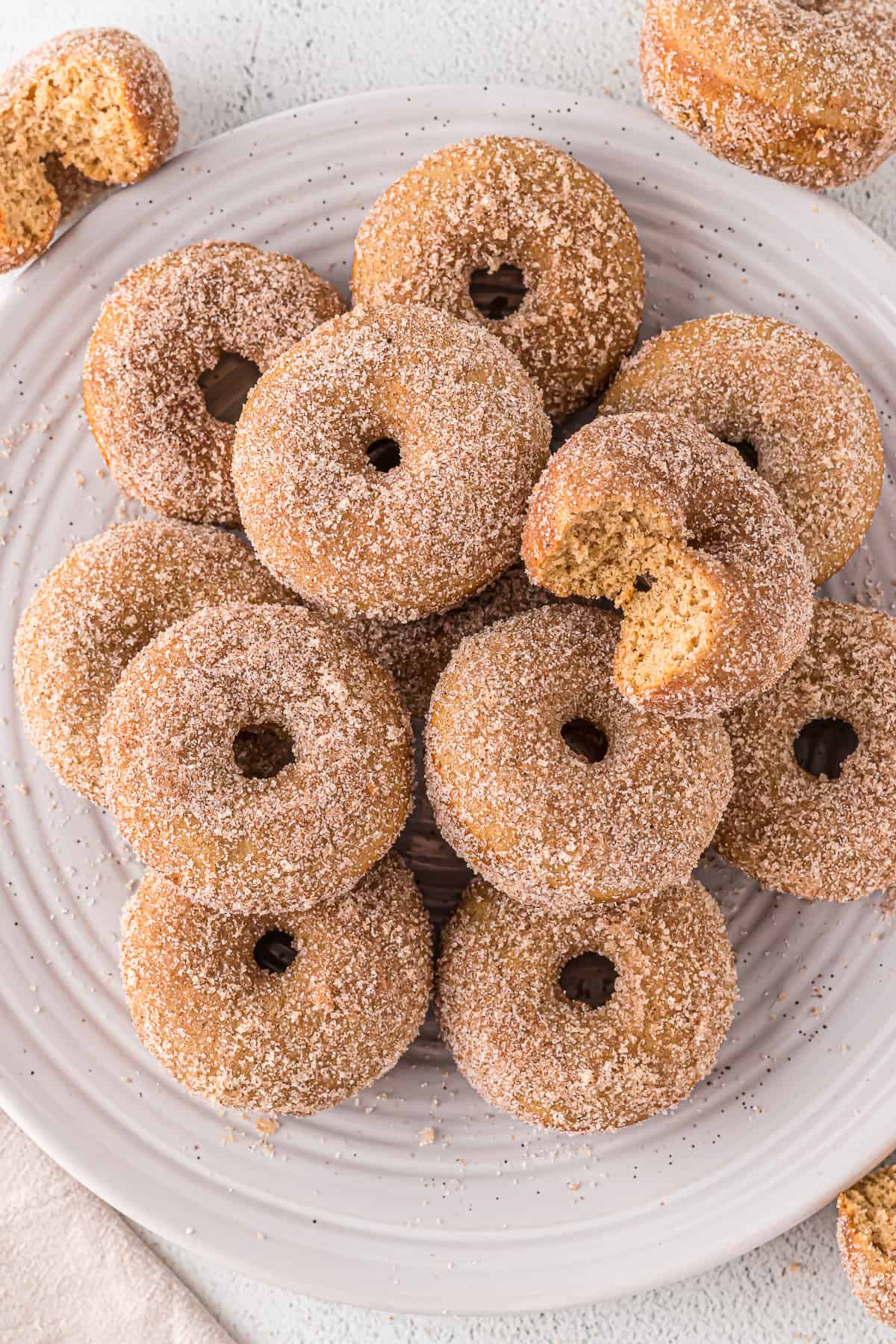 Baked apple cider donuts on a plate.