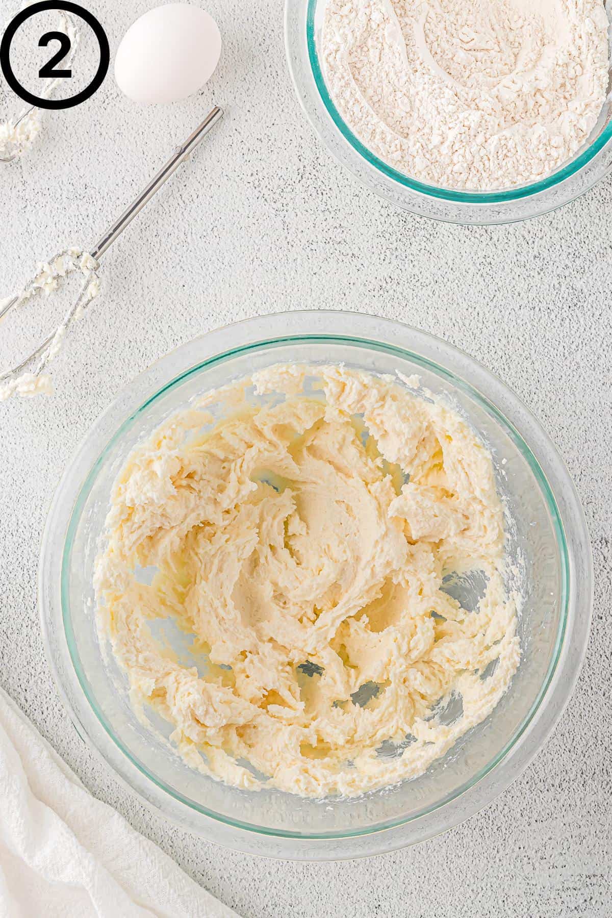 Non-dairy butter and sugar creamed together in a glass bowl.