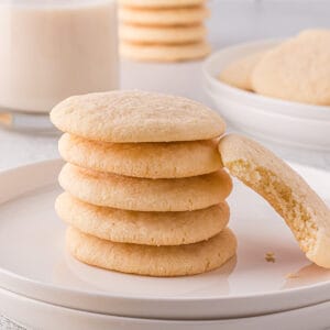 Dairy-free sugar cookies stacked on a plate.