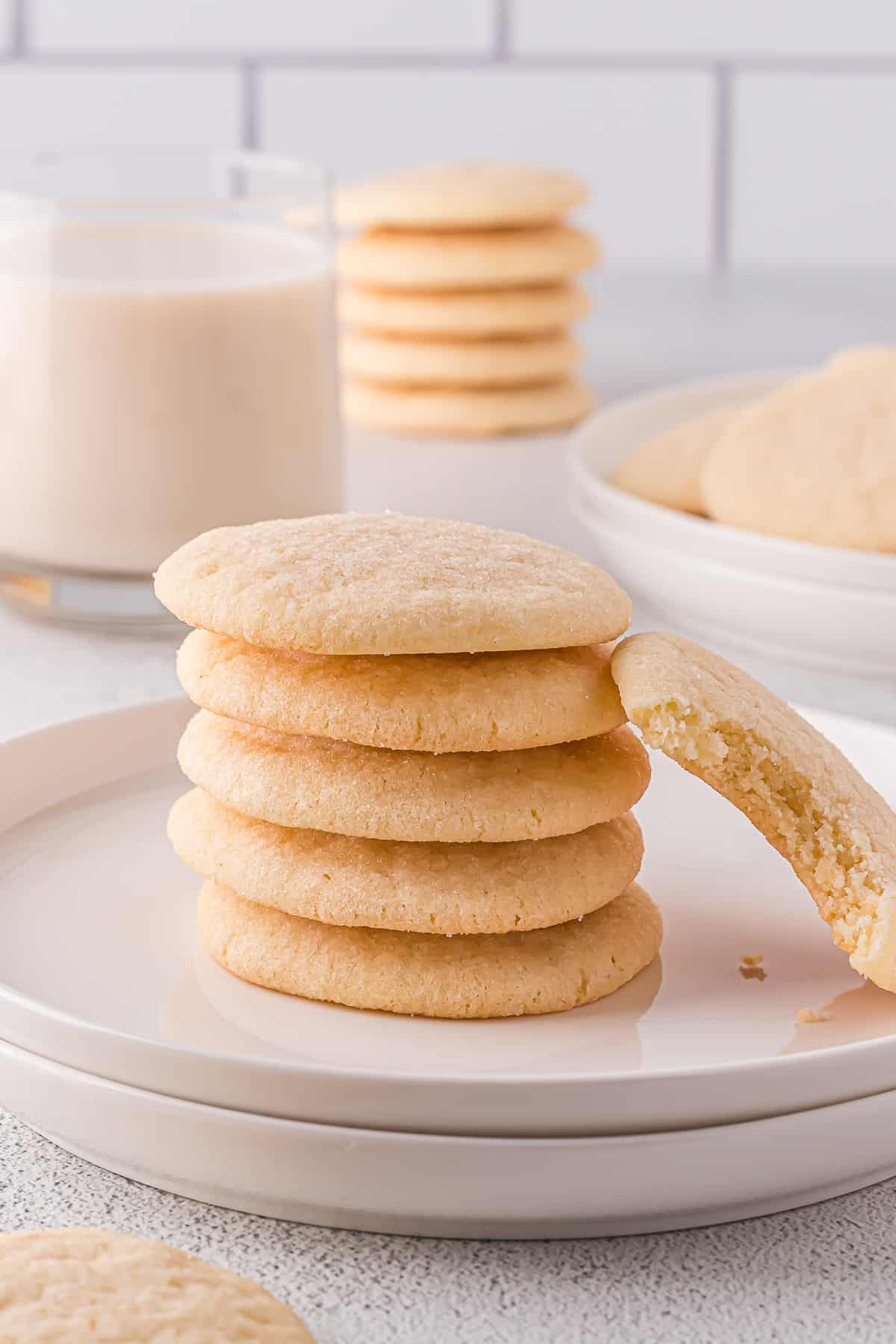 Dairy-free sugar cookies stacked on a plate.