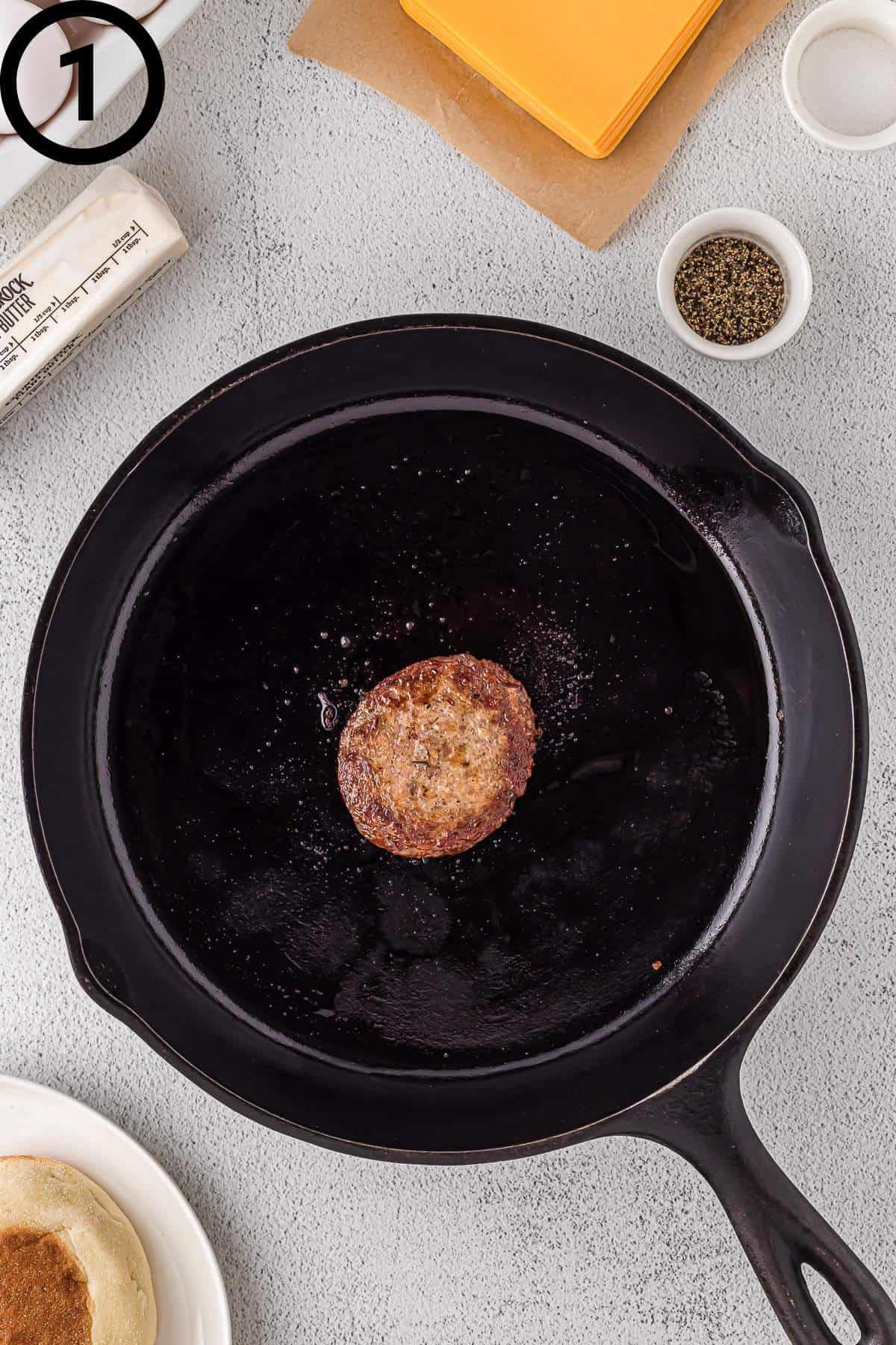 Cooked sausage on a cast iron skillet.