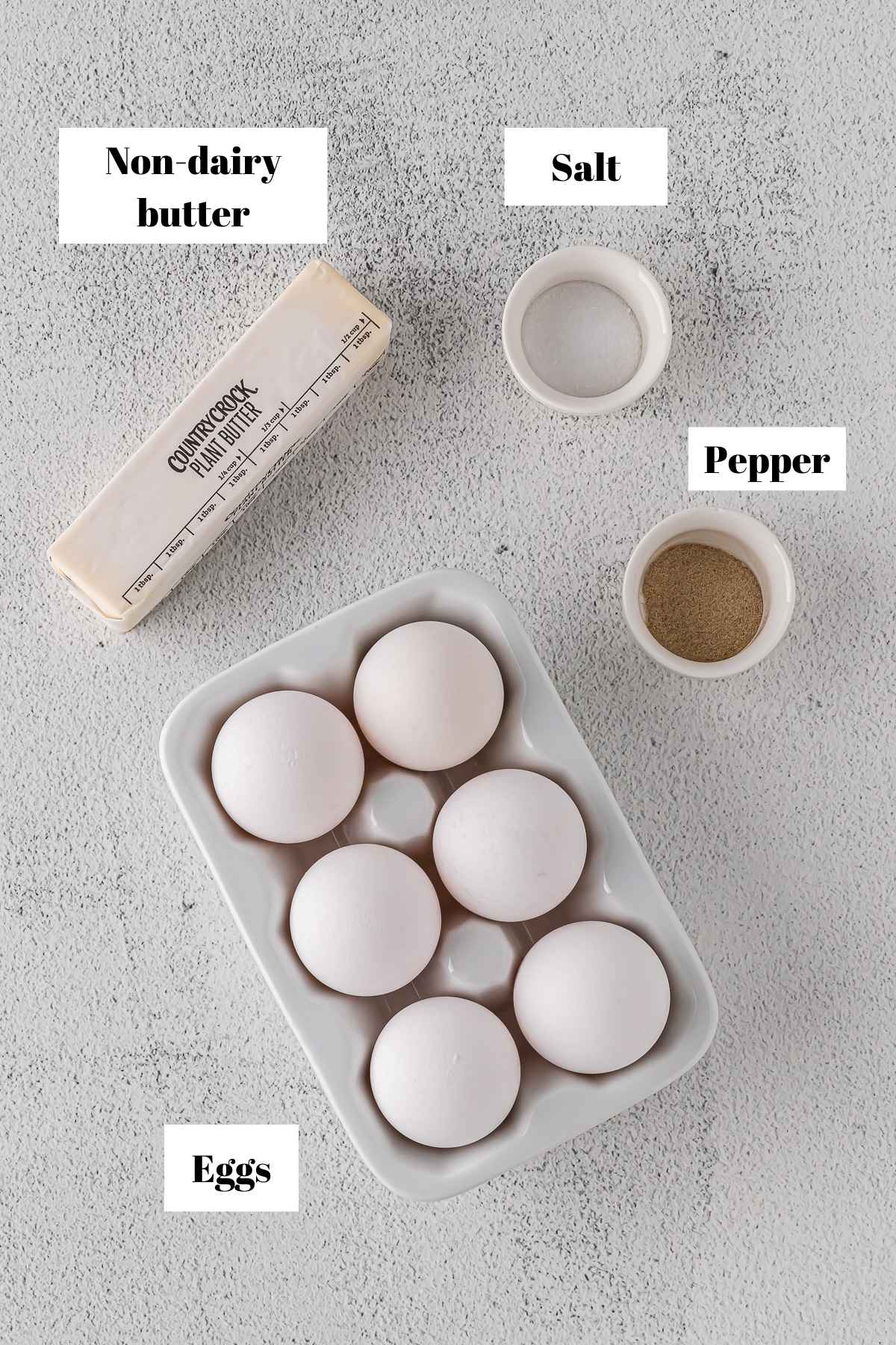 Ingredients to make scrambled eggs without milk. Text on image for labeling ingredients.