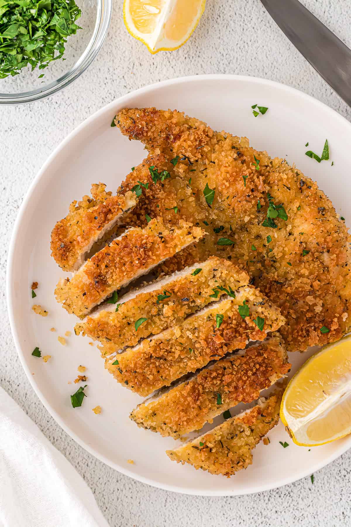 Panko crusted chicken on a white plate.