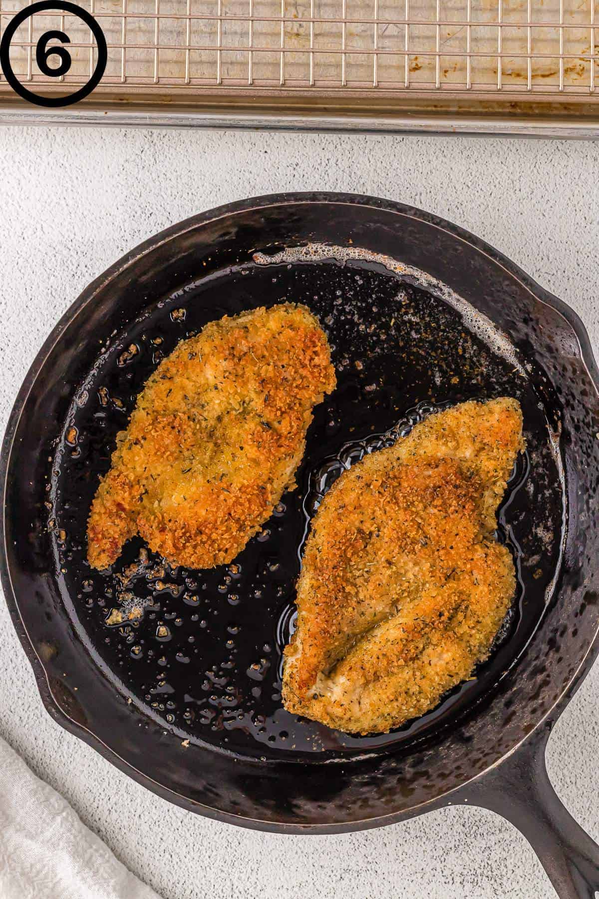 Shallow frying the chicken in a cast iron skillet.