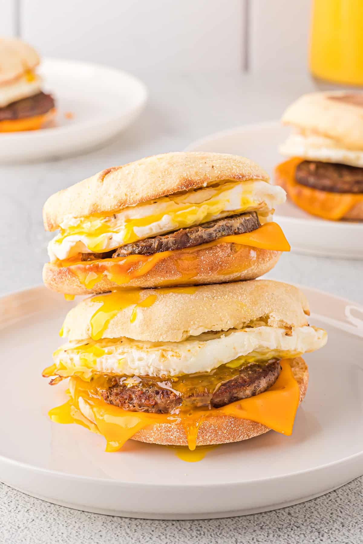 Two sausage breakfast sandwiches stacked on each other.