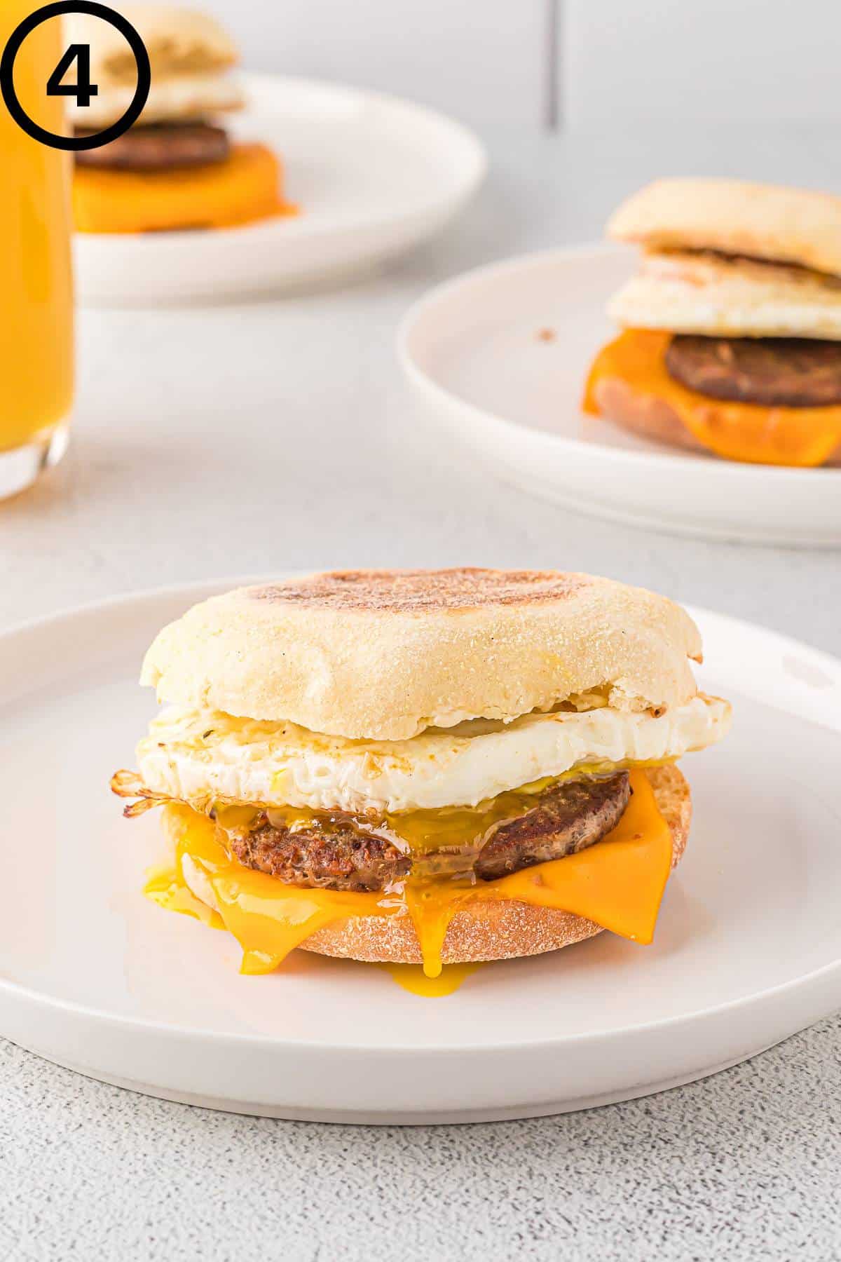 Single sausage breakfast sandwich on a plate.