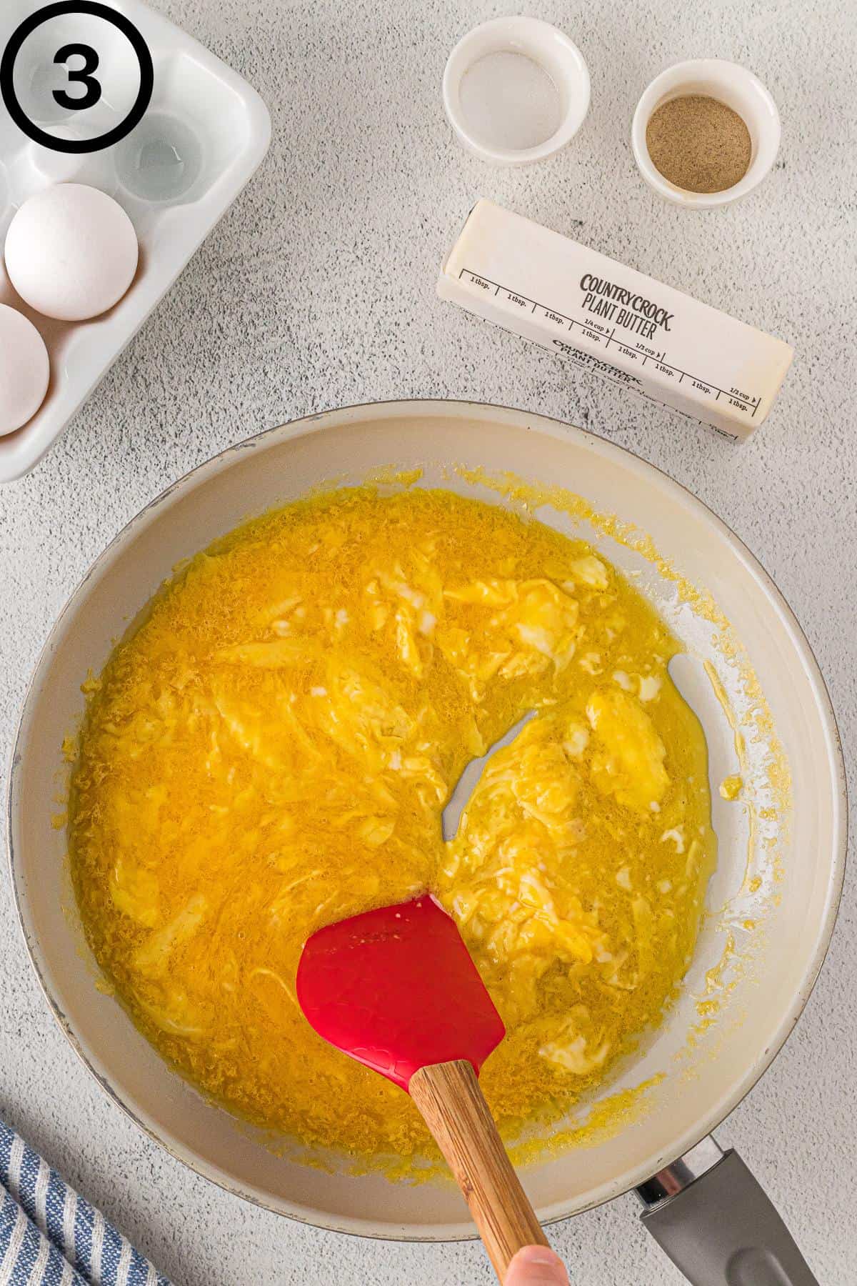 Scrambling the eggs in a non-stick pan.