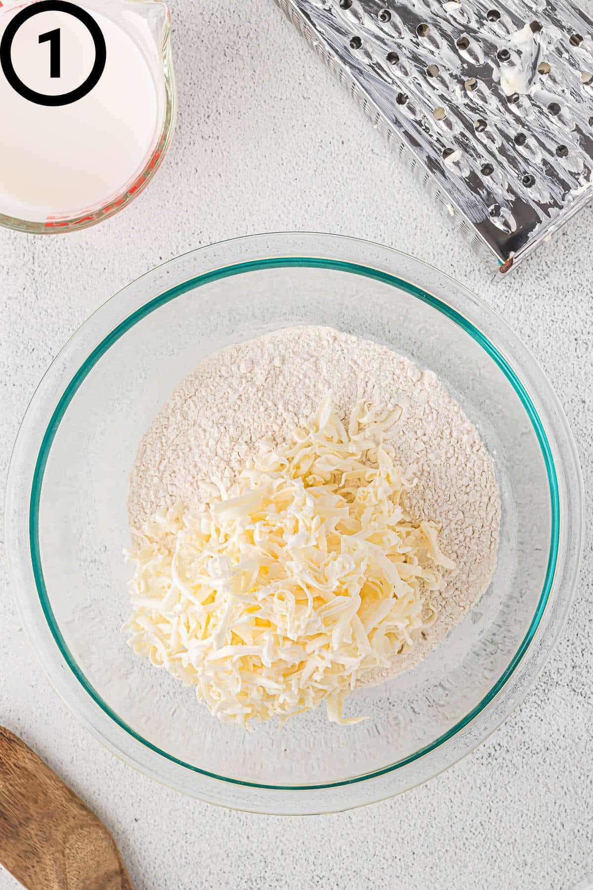 Self-rising flour and grated non-dairy butter in a bowl.