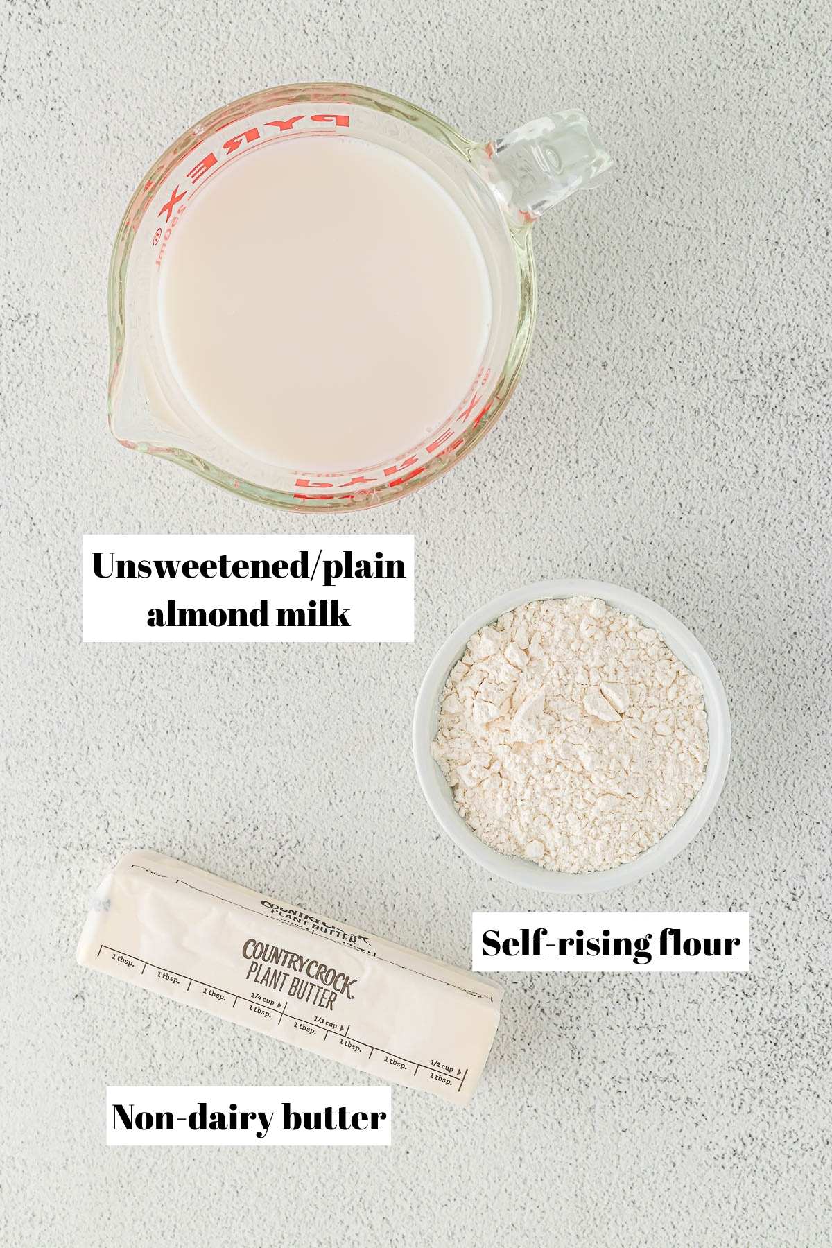 Ingredients to make 3 ingredient drop biscuits. Text on image to label ingredients.