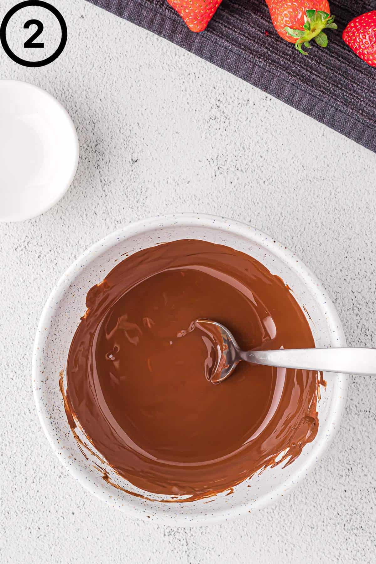 Melted chocolate in a white bowl.