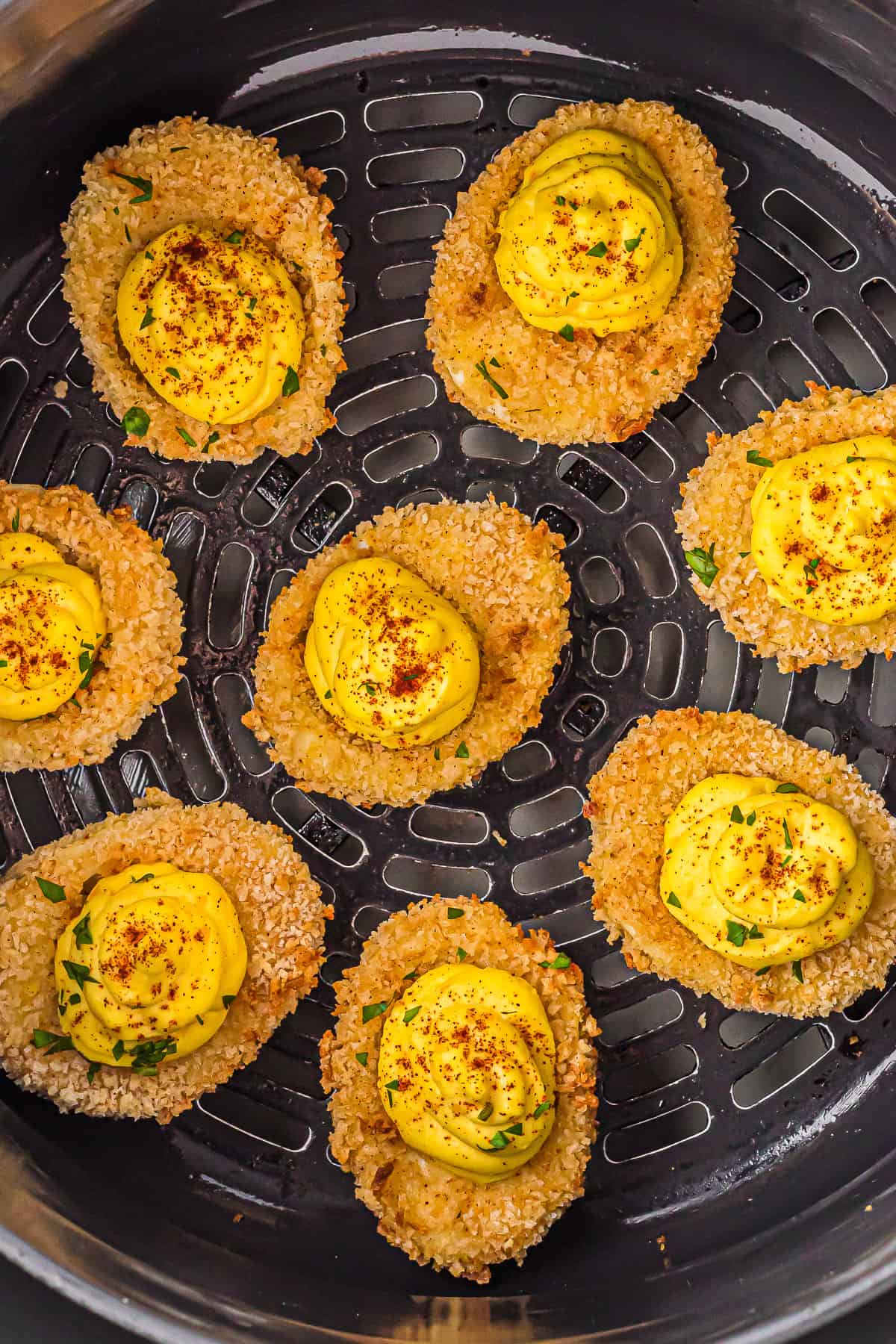 Air fried deviled eggs in the air fryer basket.